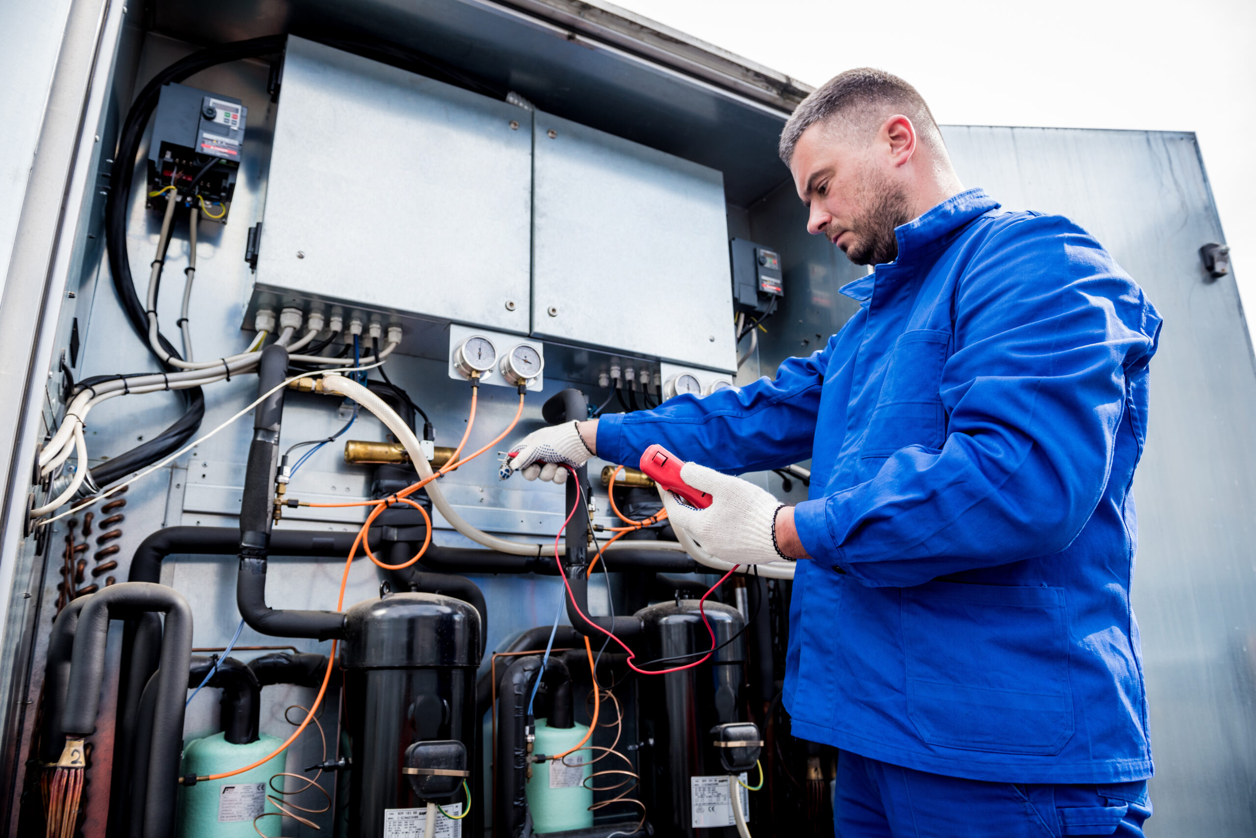 Image of a technician inspecting a commercial refrigeration system in Albuquerque